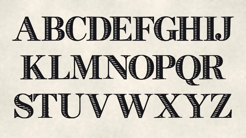 Uppercase A to Z of INK FILIGREE in three rows of black inline serif capitals on laid paper.