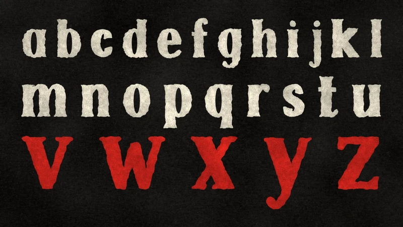 Lowercase a to z in three rows that grow larger on black paper, the last row v w x y z in red.